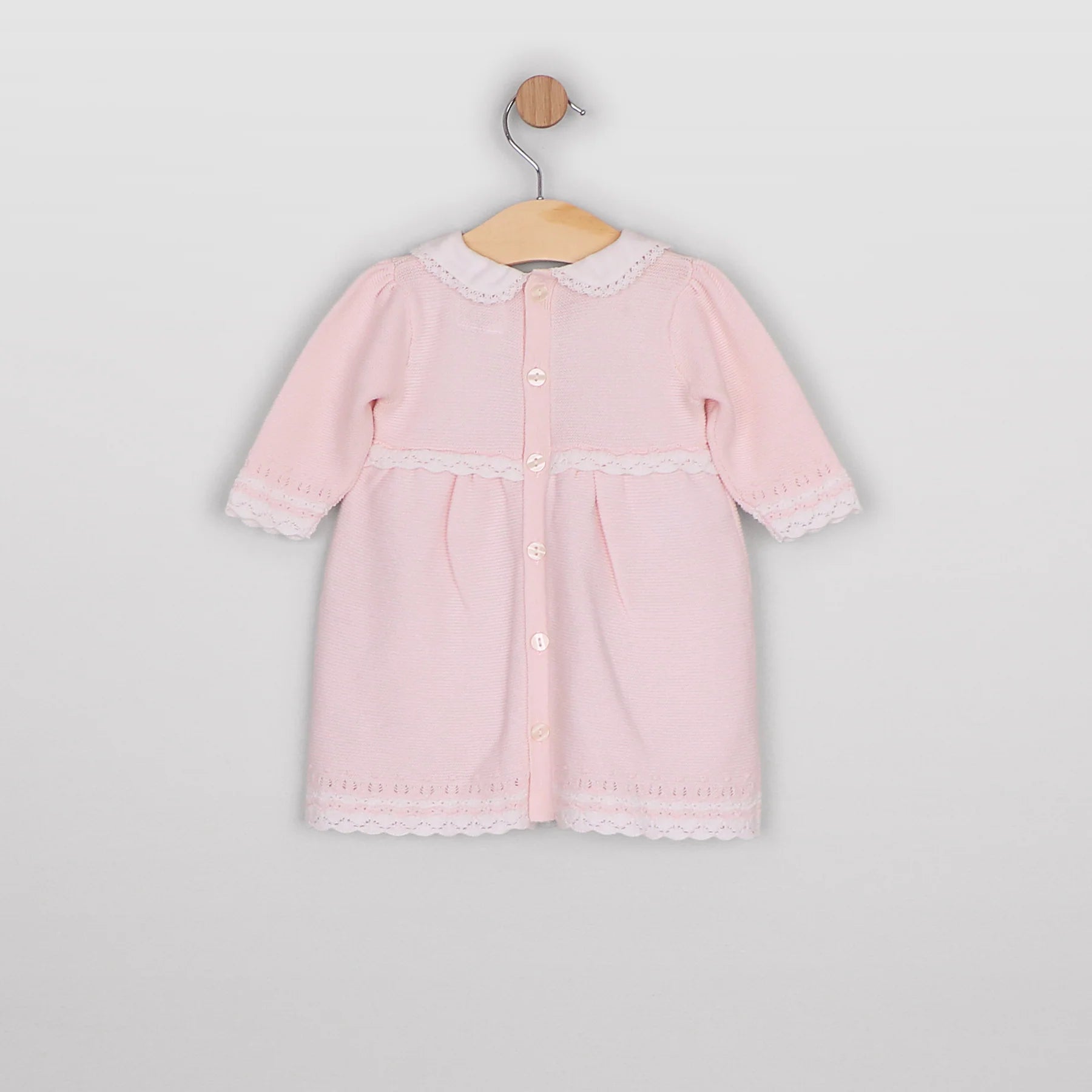 Back view of the Emile et Rose Millie pale pink knitted baby girls dress