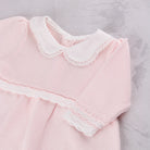 Close-up of the scalloped collar and crochet lace on the Emile et Rose Millie baby girls dress