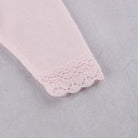 Close-up of the knitted pink lace cuff detail on the Emile et Rose Minny baby girls outfit