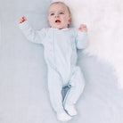 Emile et Rose baby boys blue babygrow lying flat full length
