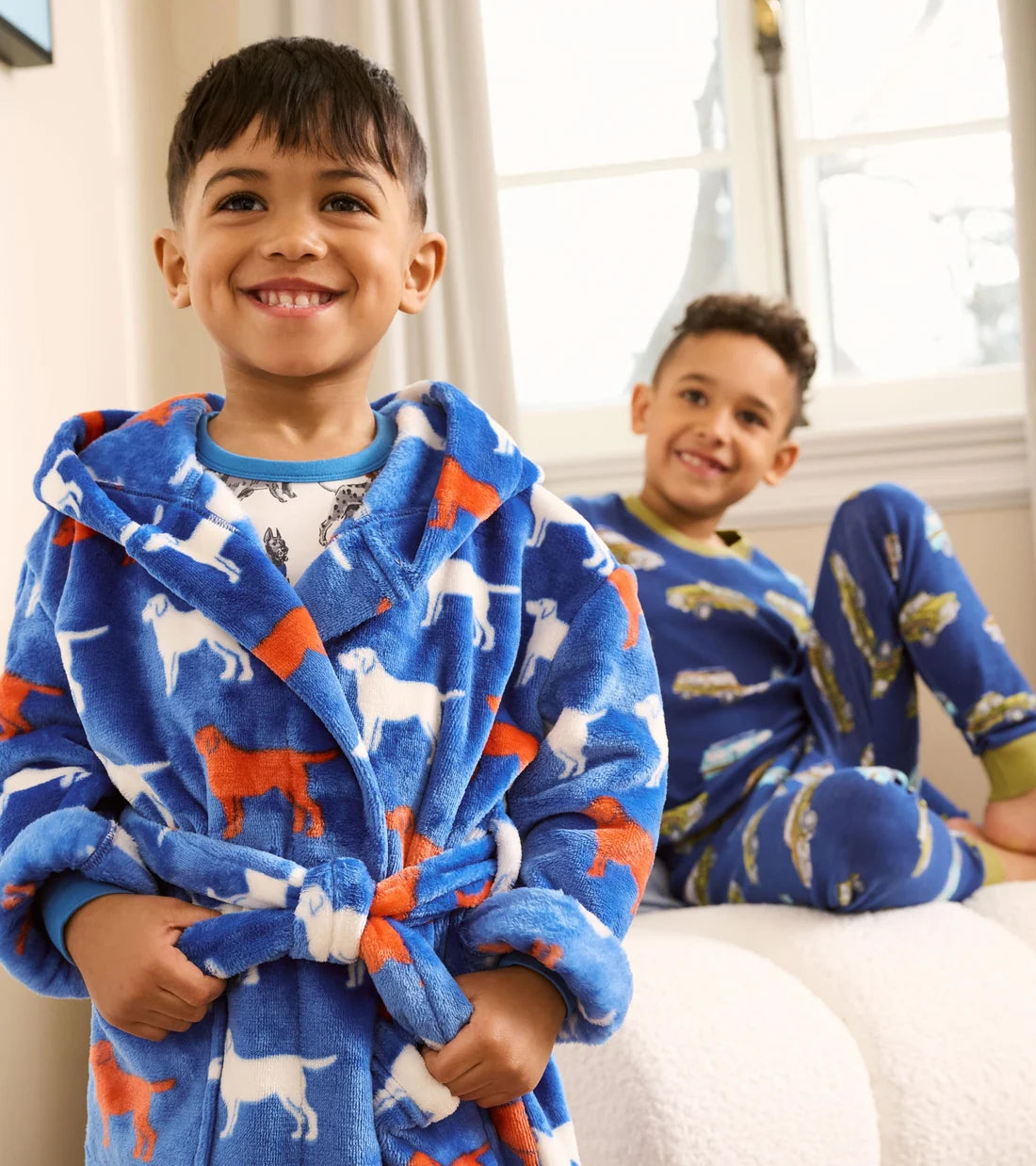     Boy wearing Hatley blue Dog Silhouette fleece dressing gown