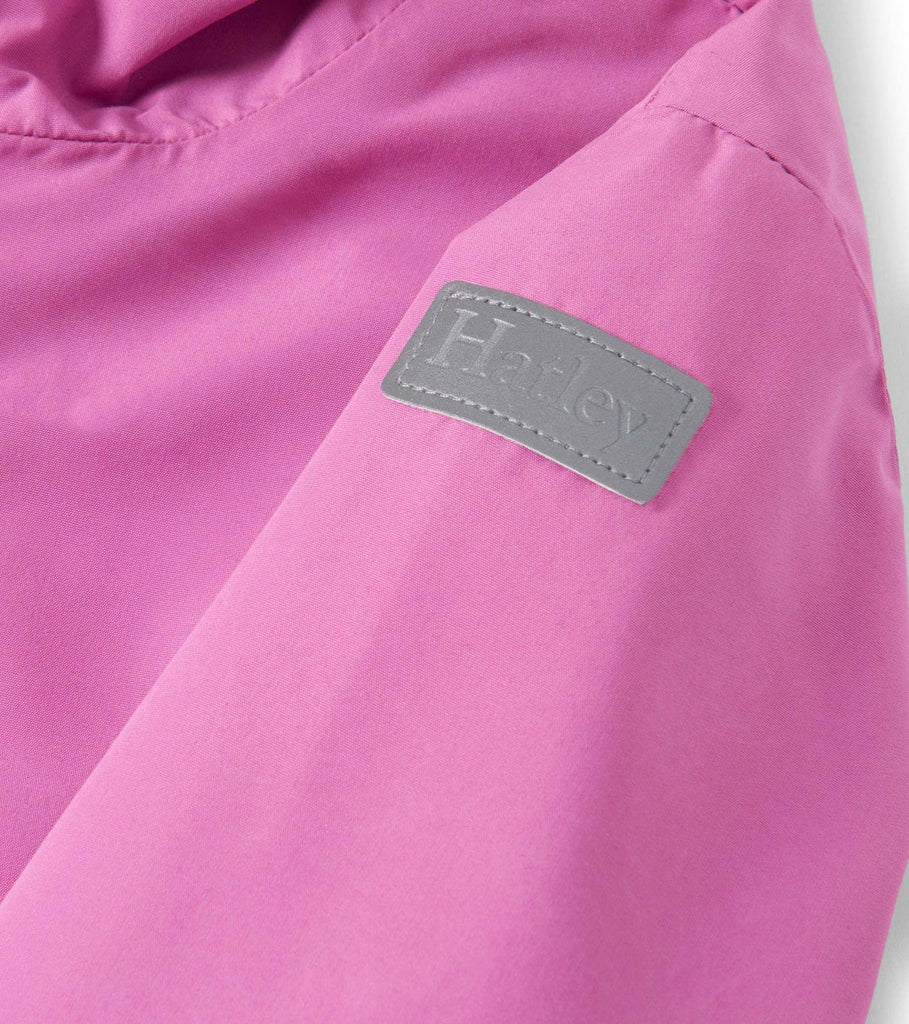 Close Up of Hatley Girls Heart Swans Colour-Reveal Jacket and logo badge on shoulder 