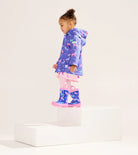 Child wearing Hatley Girls Hearts & Horses raincoat with matching purple boots 
