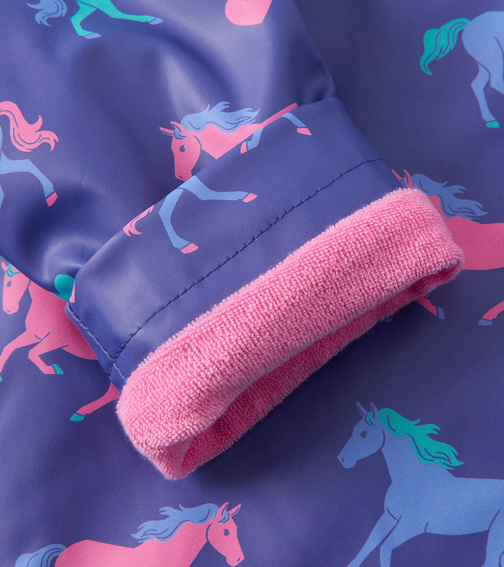 Cuff detail showing warm pink lining on Hearts & Horses raincoat