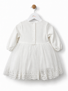     Back view of iDO Mini baby girls ivory christening dress with long sleeves and button fastenings