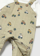     Close-up of colourful tractor print and popper fastening on Mayoral baby dungarees