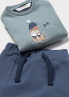Close-up of the Mayoral baby boys blue sweatshirt with cute winter dog motif and navy drawstring joggers