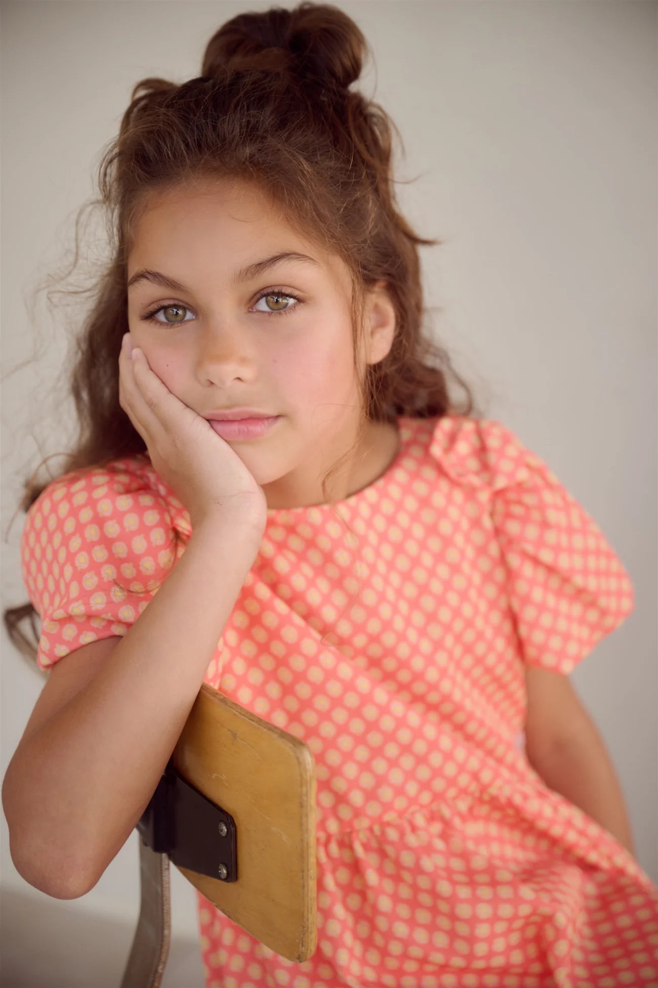 Close-up of NoNo girls polka dot printed dress with balloon sleeve and bow shoulder detail