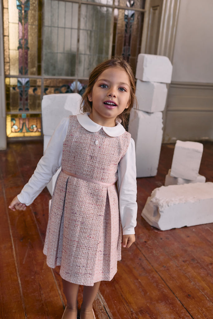 Patachou girls pink tweed sleeveless dress with collared shirt underneath modelled by little girl.