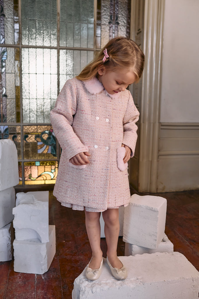 Girl aged 5 wearing Patachou 
 pink tweed coat with faux fur trim