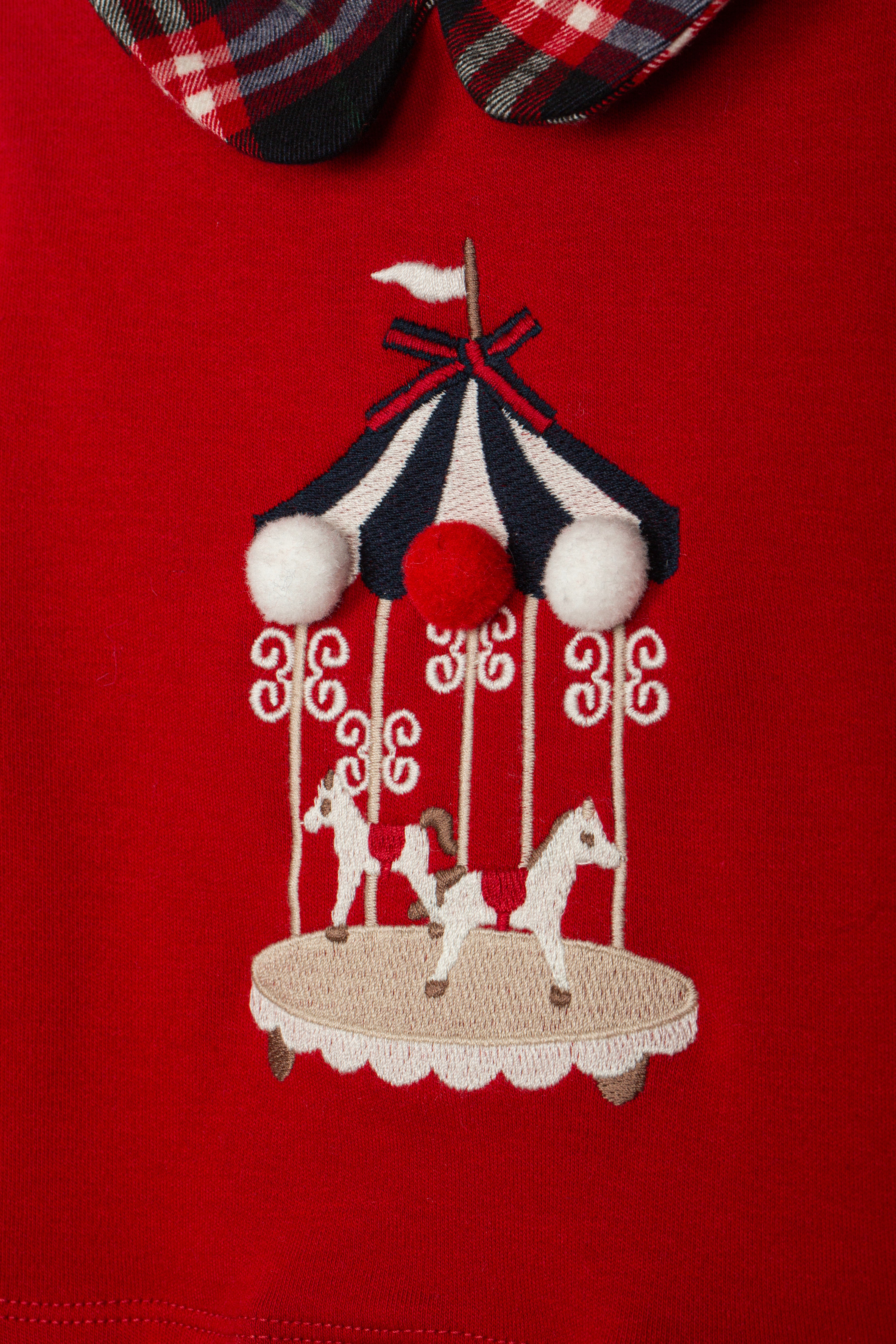 Girl wearing Patachou red carousel and tartan Christmas dress