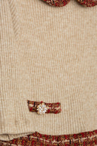 Close-up of Patachou tweed dress pocket with jewel button detail