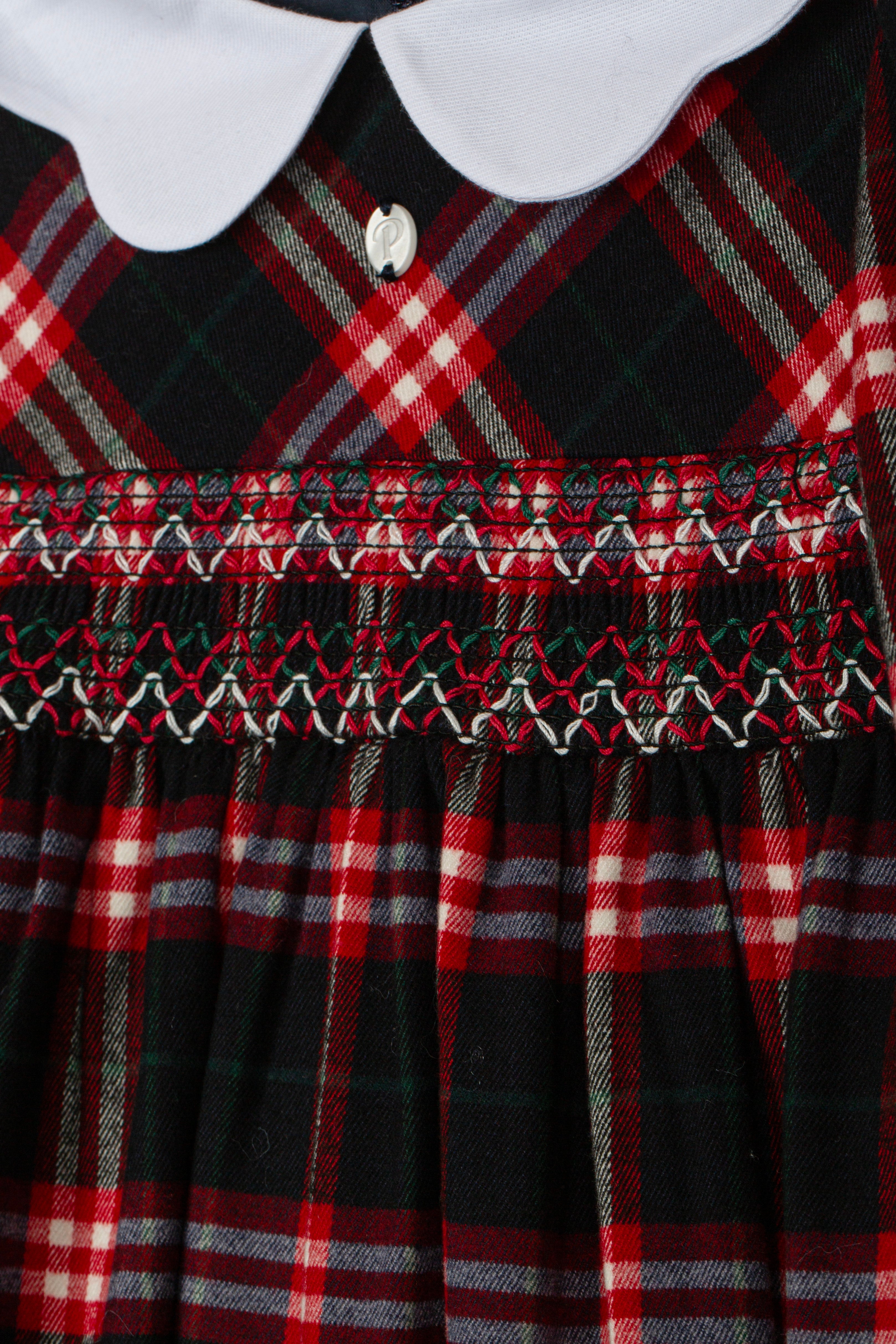 Close-up of Patachou Balmoral tartan dress with detailed smocked bodice
