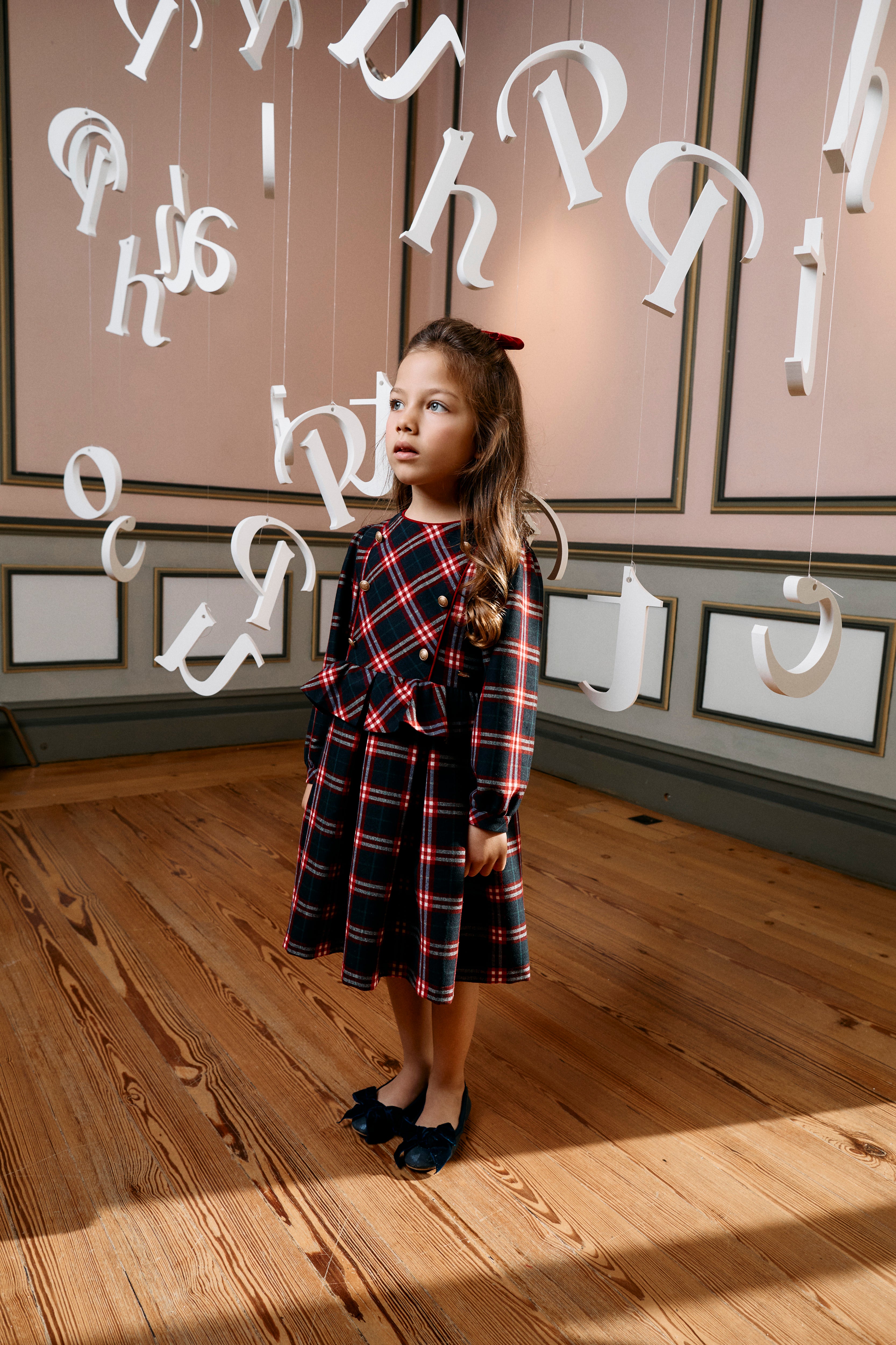 Girl wearing Patachou Balmoral navy and red tartan Christmas dress