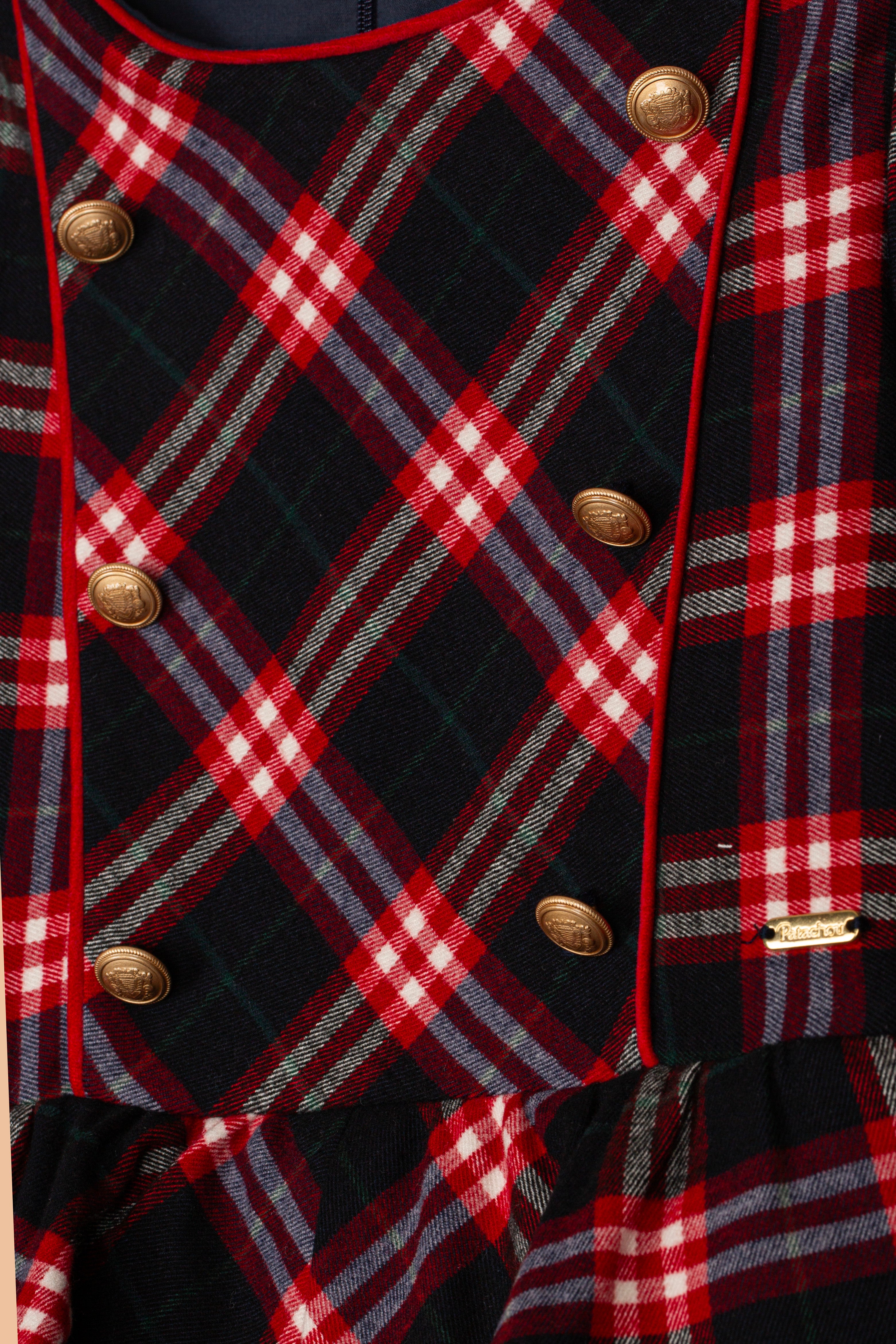 Close-up of Patachou Balmoral tartan girls dress with gold button detailing