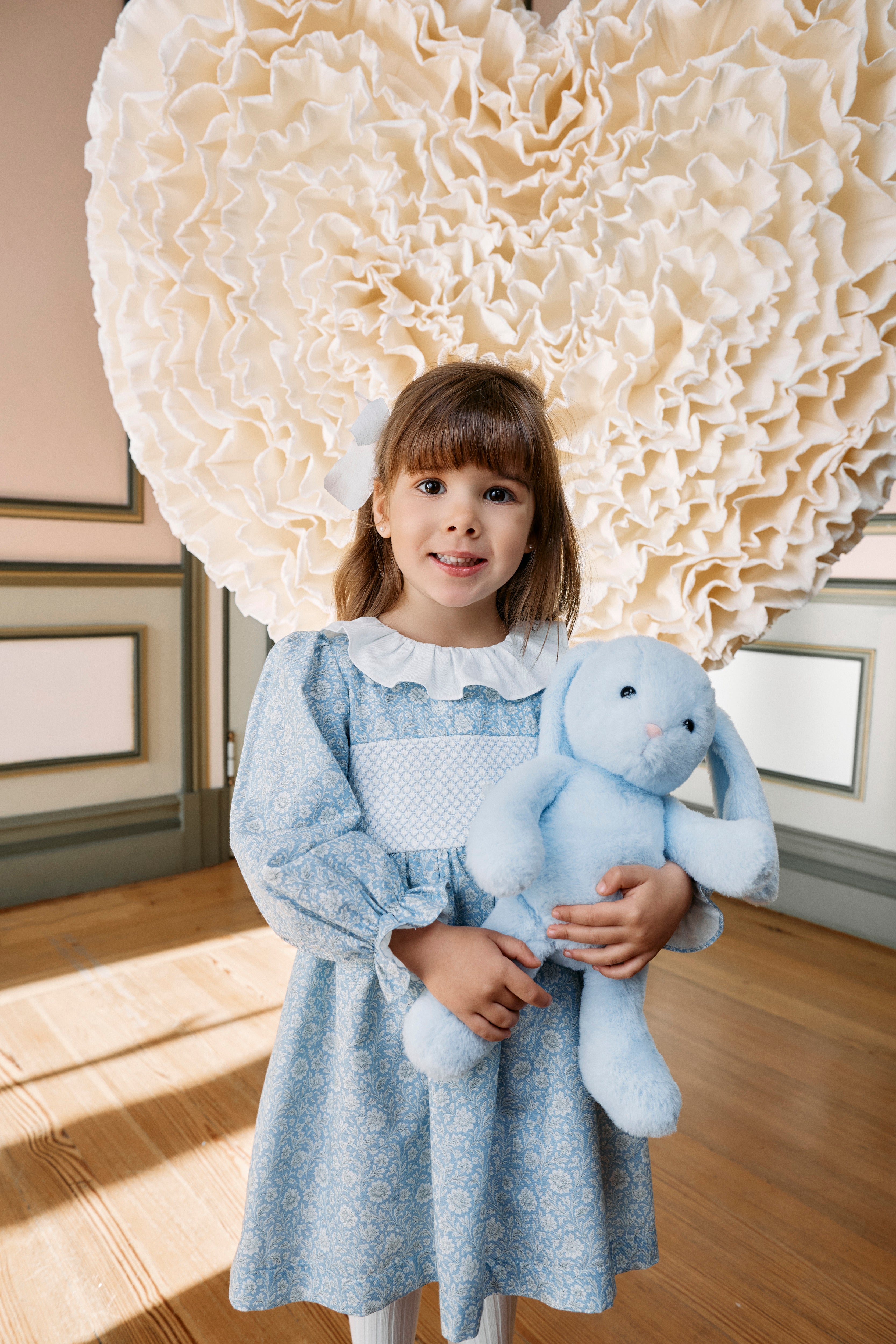 Girl wearing Patachou blue floral smocked cotton dress