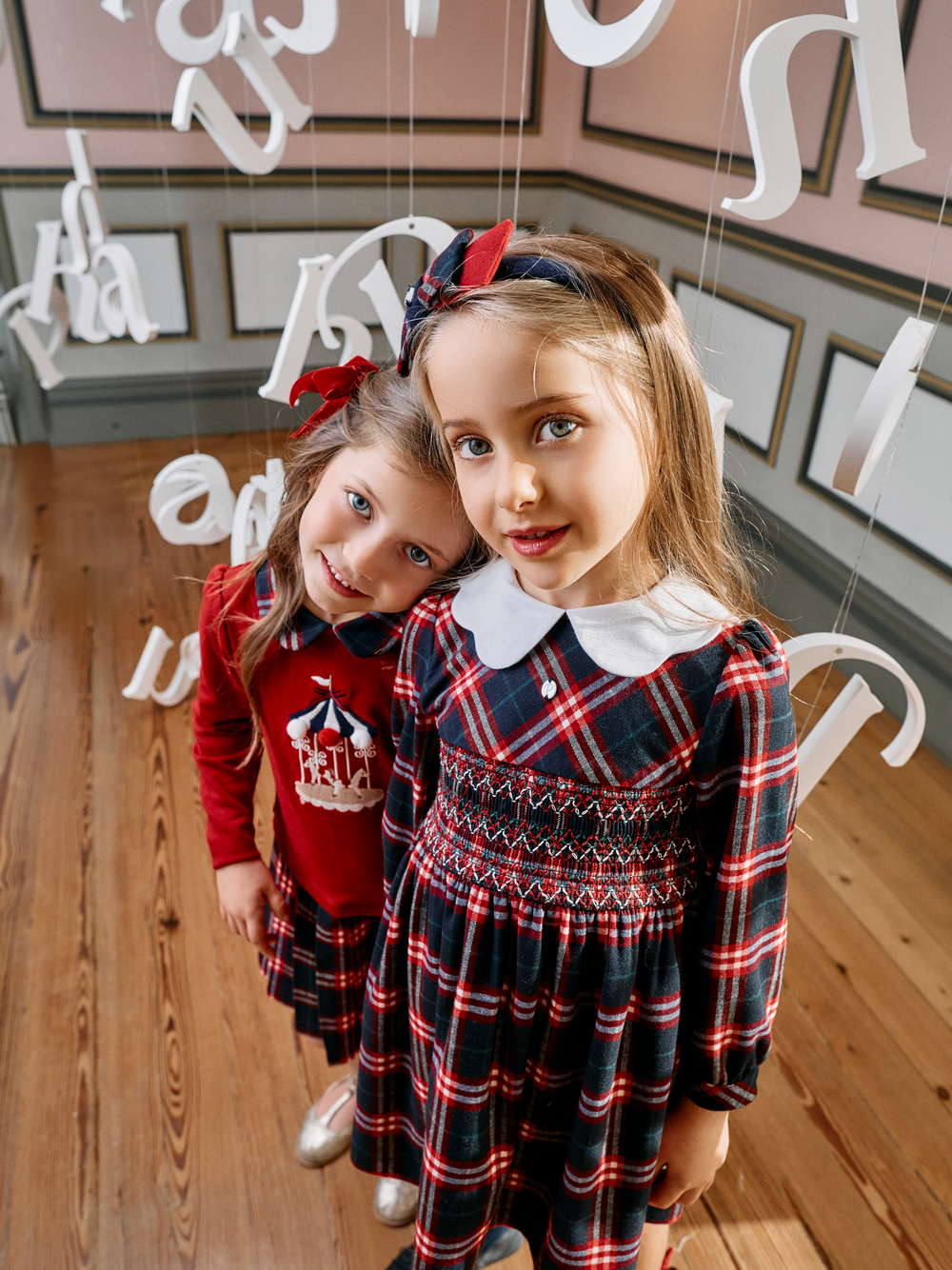 Girls wearing Patachou tartan Christmas dresses with matching Marine hairband