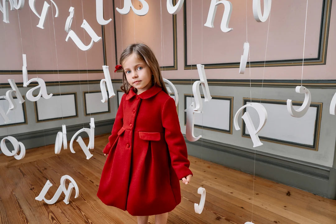 Girl wearing Patachou red dress coat for a winter occasion