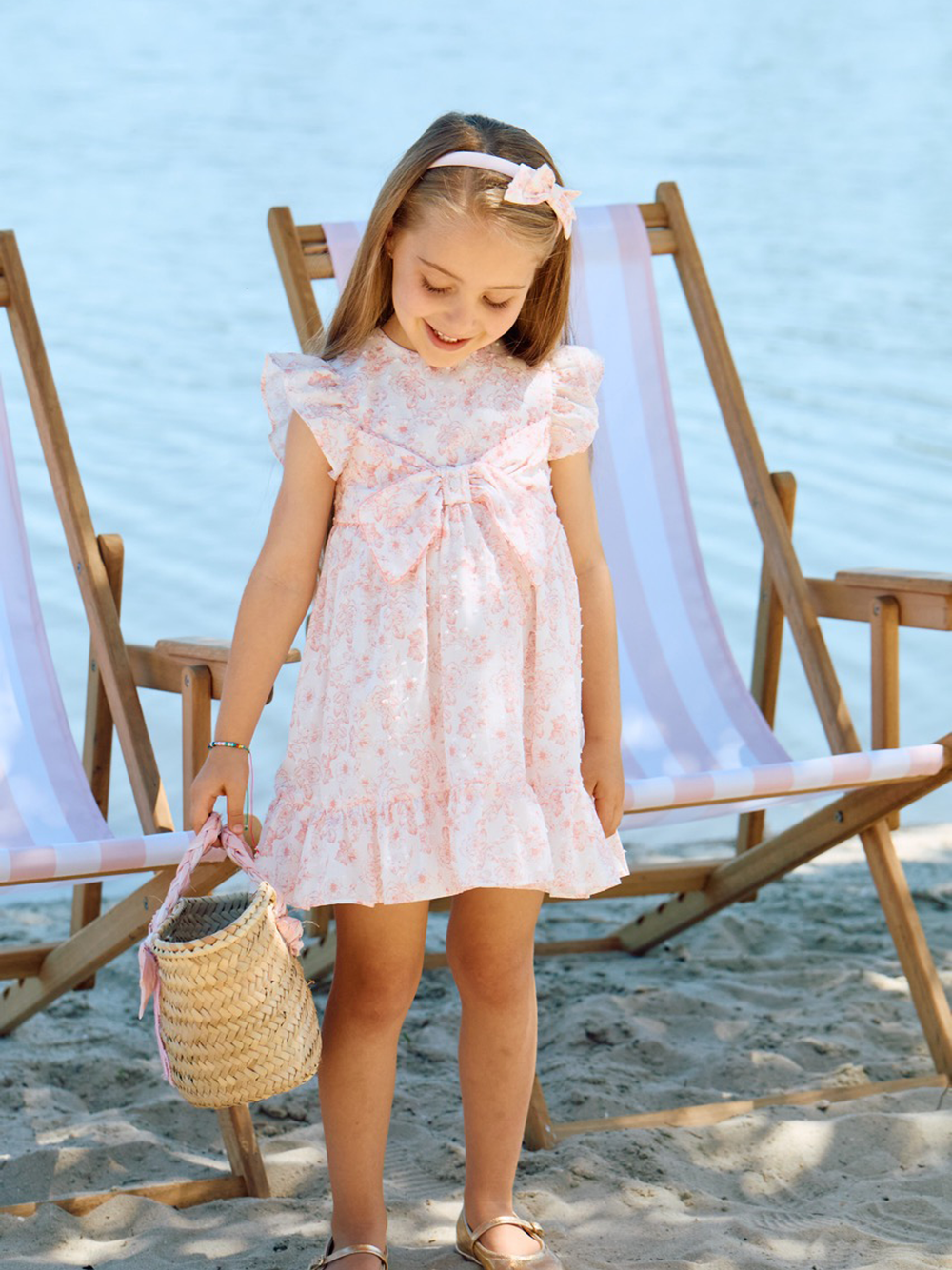 Patachou girls pink floral dress worn outdoors at an event 