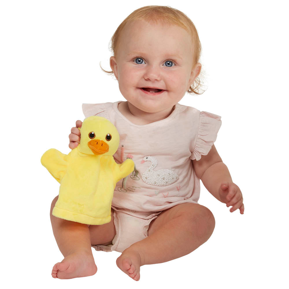Baby holding a yellow My First Duck hand puppet during interactive play