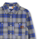 Close-up of Timberland boys checked shirt with button front and chest pockets