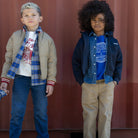 Boy wearing Timberland blue checked shirt layered with casual jacket and jeans