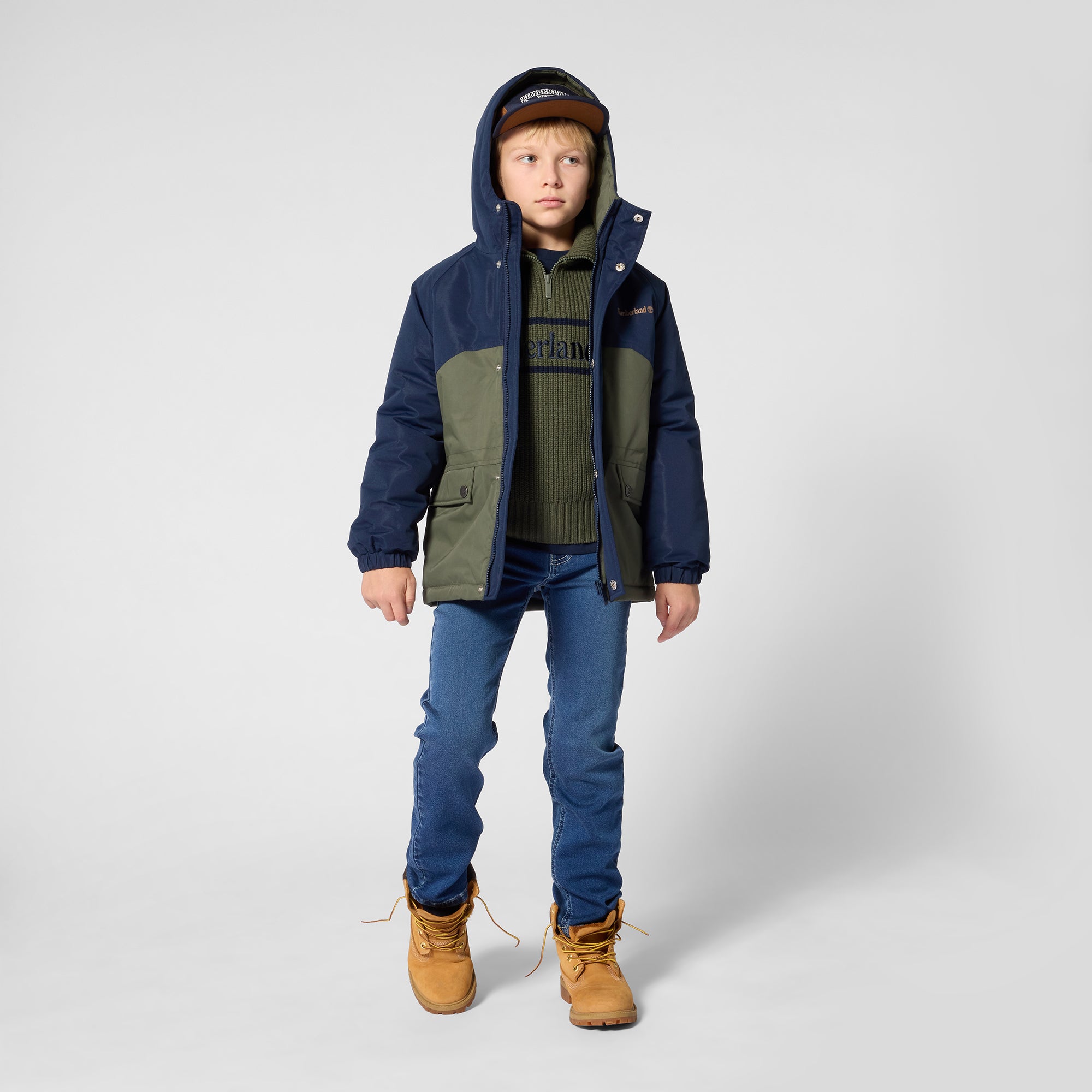 Timberland boys blue straight leg jeans worn with a navy and green winter jacket
