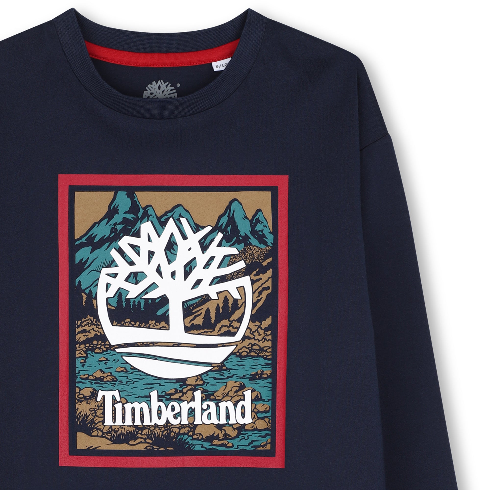 Close-up of Timberland tree logo on boys navy graphic long sleeve T-shirt
