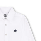 Close-up of Timberland boys white shirt showing collar, buttons and embroidered tree logo