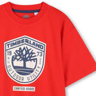     Timberland boys red logo T-shirt close-up with outdoor utility motif
