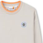 Timberland boys beige crew neck sweatshirt close-up with orange trim