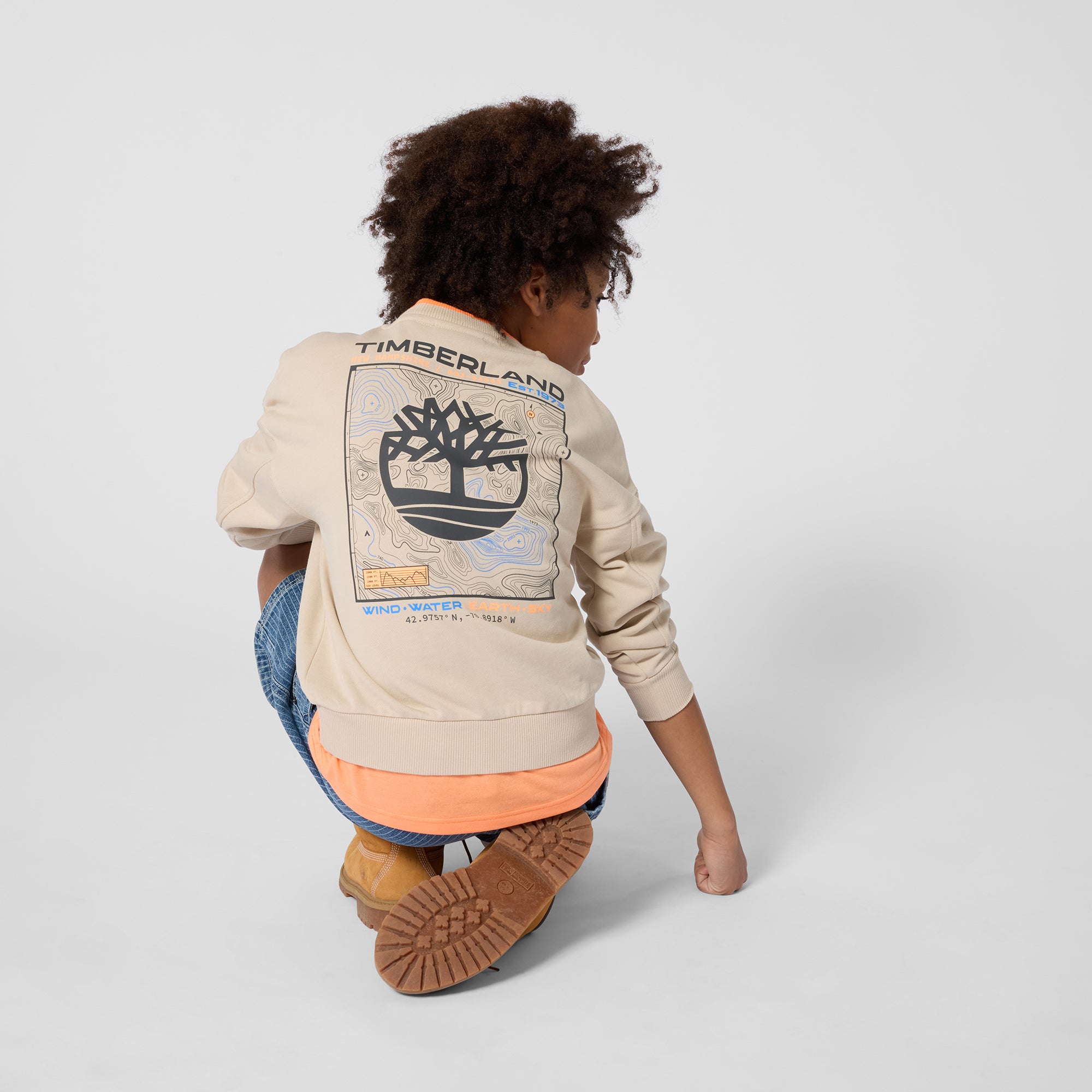Timberland boys beige Timberland sweatshirt back view worn with jeans