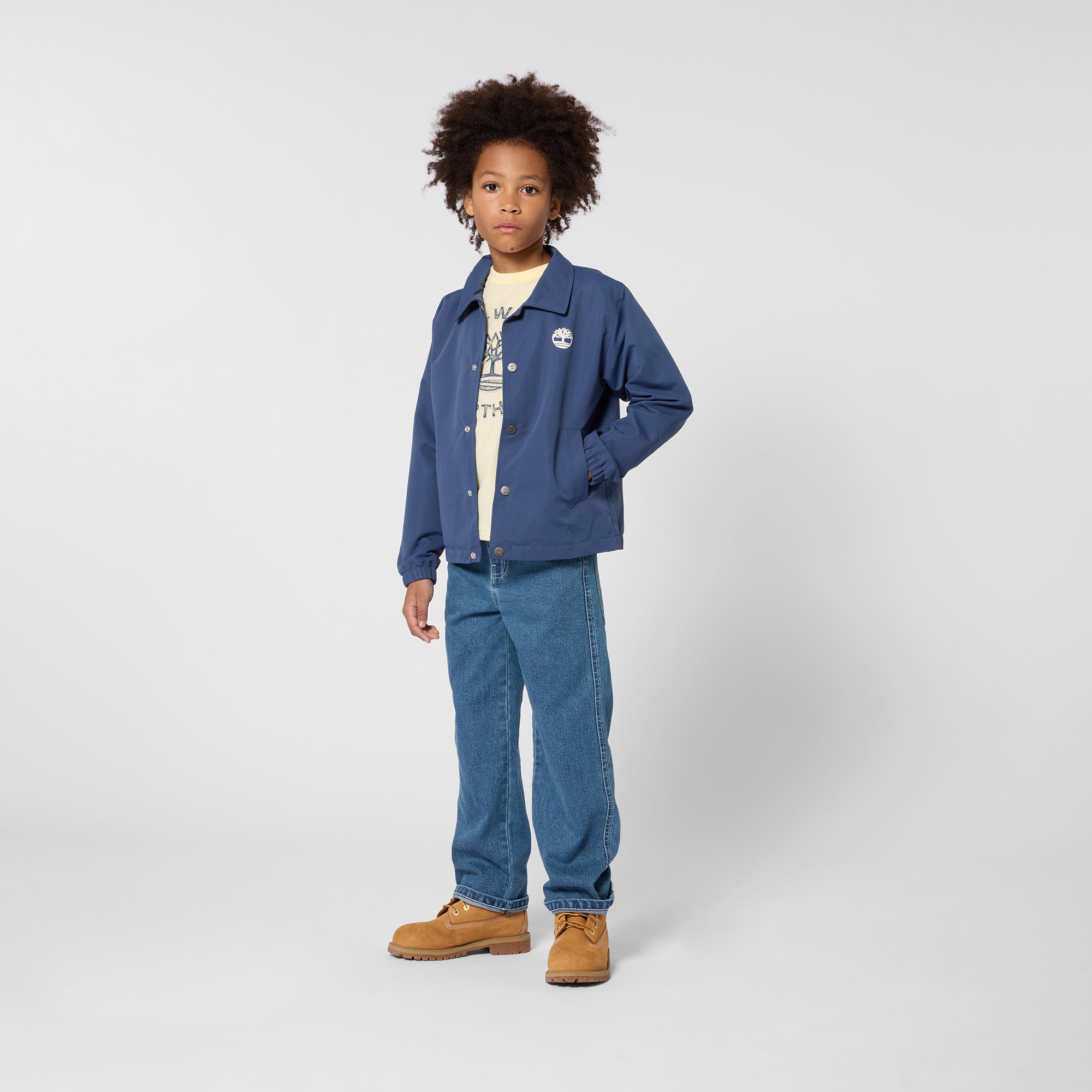     Timberland boys navy button jacket styled with jeans