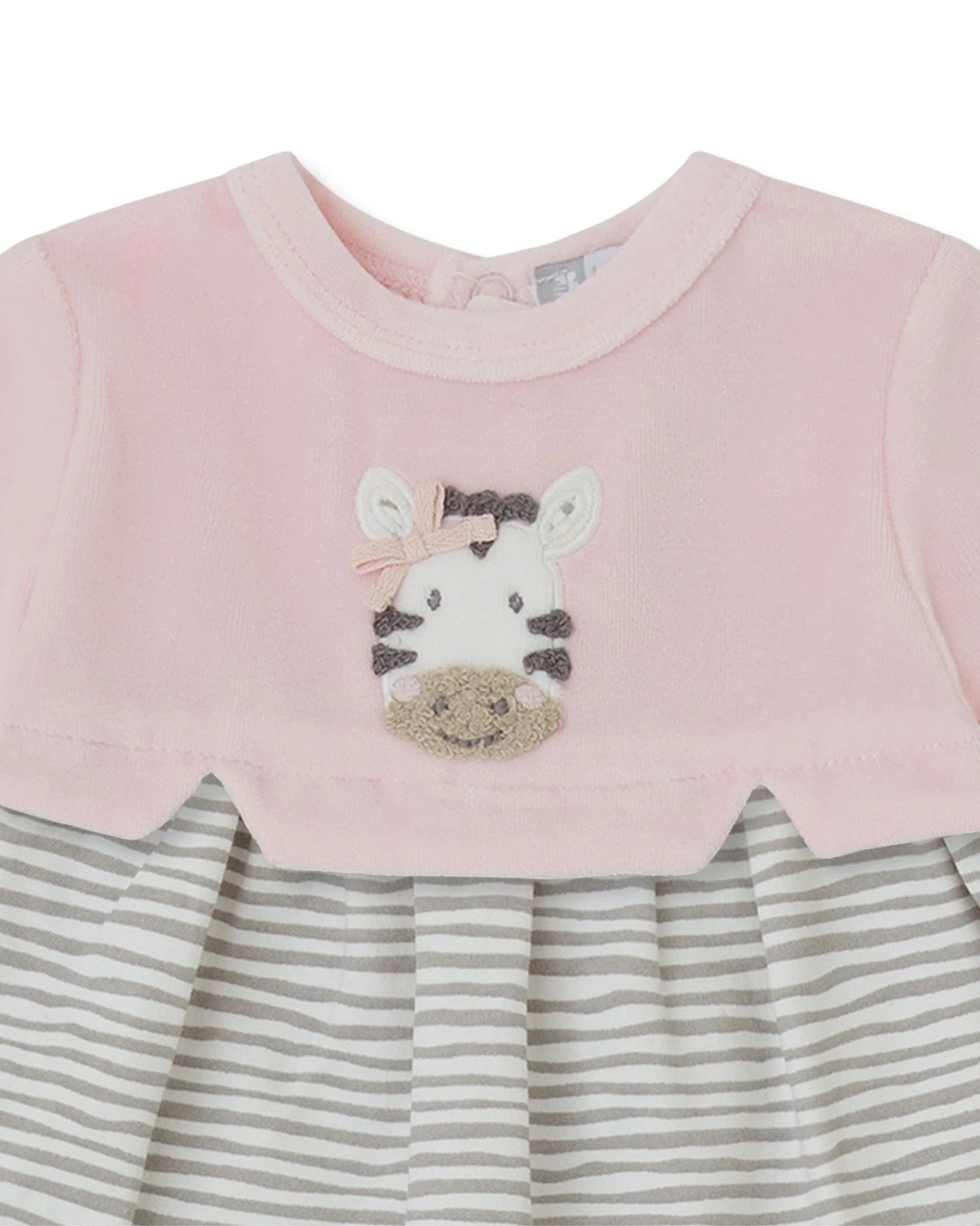 Close-up of Tutto Piccolo pink baby dress with embroidered zebra and striped skirt