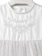 Close-up of My Christening Day floral embroidery on the Visara white satin gown