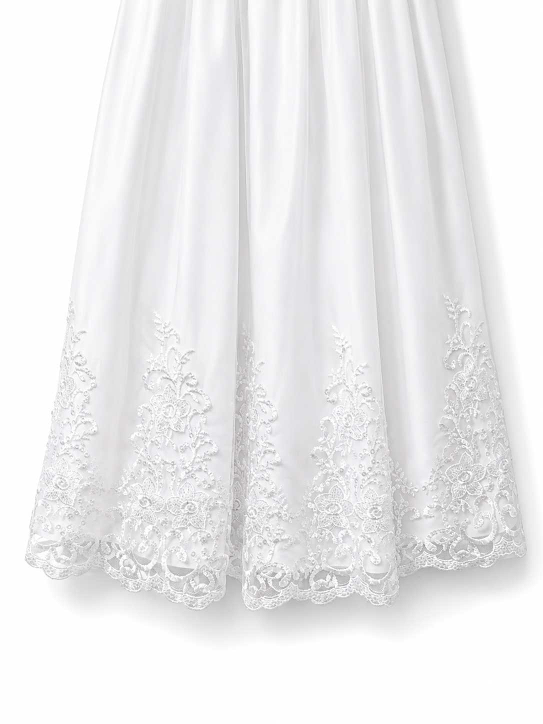 Close-up of the ornate floral lace embroidered hem on the Visara white christening gown