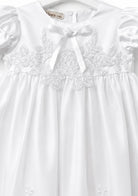 Close-up of the lace embroidered bodice and satin neckline bow on the Visara christening gown