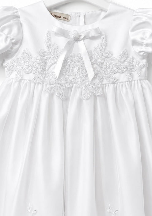 Close-up of the lace embroidered bodice and satin neckline bow on the Visara christening gown